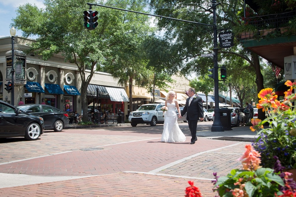 A bride and groom walking through historic Winter Park