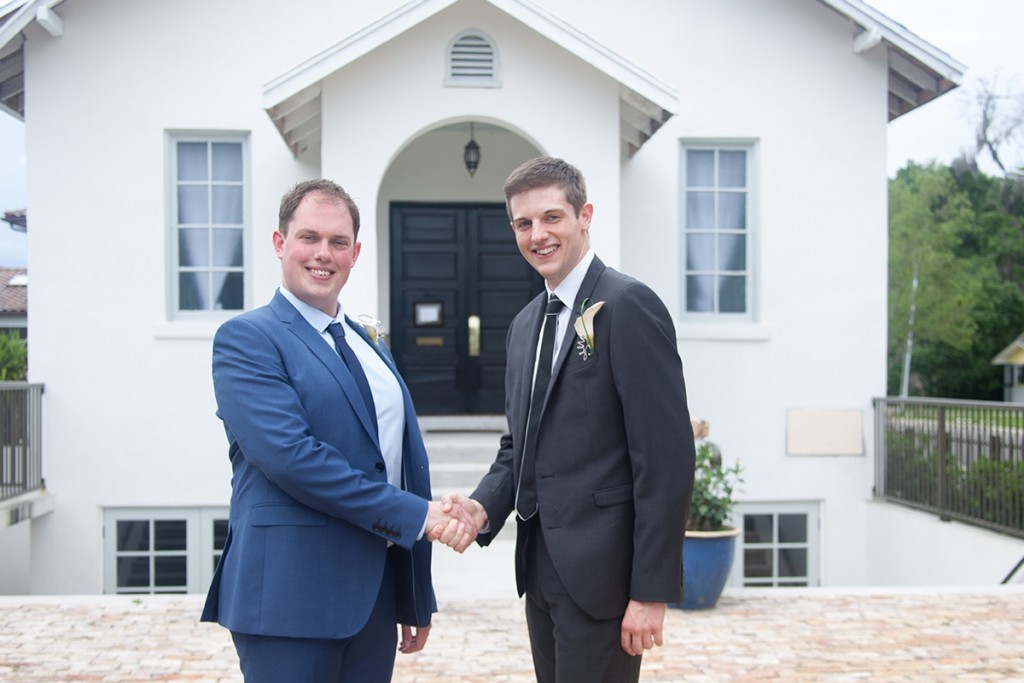A handshake between groom and best man at this UK destination wedding